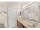 The bathroom features a double sink vanity, a large mirror, and a soaking tub at 11225 Cypress Trail Dr, Orlando, FL 32825