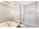 Bright bathroom with a white shower-tub combo and a single sink vanity with a large mirror at 11225 Cypress Trail Dr, Orlando, FL 32825