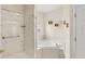 Bathroom featuring a soaking tub, white marble shower, and natural lighting at 11225 Cypress Trail Dr, Orlando, FL 32825