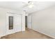 Bedroom with mirrored closet doors, ceiling fan, and access to hallway at 11225 Cypress Trail Dr, Orlando, FL 32825