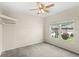 Bedroom with window and ceiling fan with a view of the outside at 11225 Cypress Trail Dr, Orlando, FL 32825