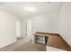 A bonus room with a built-in desk on the second floor featuring neutral carpeting at 11225 Cypress Trail Dr, Orlando, FL 32825
