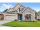 Single-Gathering home with stone facade, manicured lawn, blue front door and shutters at 11225 Cypress Trail Dr, Orlando, FL 32825
