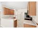 Bright kitchen featuring wooden cabinets, white countertops, and tile flooring throughout at 11225 Cypress Trail Dr, Orlando, FL 32825
