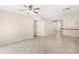 Large living area with tiled floors and staircase at 11225 Cypress Trail Dr, Orlando, FL 32825