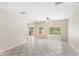 Open-concept living space with tile flooring, and sliding door to the lanai at 11225 Cypress Trail Dr, Orlando, FL 32825