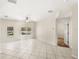 Bright living room with large windows overlooking the pool and neutral tile flooring at 11225 Cypress Trail Dr, Orlando, FL 32825