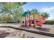Community playground with slides, swings, and climbing structures for Gathering fun at 11225 Cypress Trail Dr, Orlando, FL 32825