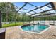 Screened-in pool with brick patio and small waterfall feature provides a great outdoor living space at 11225 Cypress Trail Dr, Orlando, FL 32825