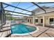 View of the pool and covered patio attached to the home, enclosed by a screen at 11225 Cypress Trail Dr, Orlando, FL 32825
