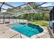 Beautiful pool with waterfall feature, surrounded by brick pavers and screened enclosure at 11225 Cypress Trail Dr, Orlando, FL 32825