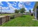 Well-maintained backyard offering ample green space, partial fence, and privacy at 1132 Sugarwood St, Davenport, FL 33837