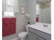 Well-lit bathroom with a modern vanity, framed art, and stylish floral accents and complementary towels at 1132 Sugarwood St, Davenport, FL 33837