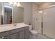 Modern bathroom with a gray vanity, white countertops, a sleek glass-enclosed shower, and elegant finishes at 1132 Sugarwood St, Davenport, FL 33837