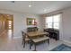 Cozy dining room with natural light, wood table and floors, and piano in the corner at 1132 Sugarwood St, Davenport, FL 33837