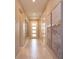 Bright and spacious hallway featuring tiled flooring and neutral wall paint with modern wall art at 1132 Sugarwood St, Davenport, FL 33837