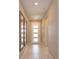 Inviting hallway with neutral tones, tiled flooring, recessed lighting and decorative mirrors on the wall at 1132 Sugarwood St, Davenport, FL 33837