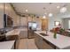 Bright kitchen with white countertops, stainless steel appliances, and gray cabinetry at 1132 Sugarwood St, Davenport, FL 33837