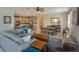 Open-concept living room with kitchen in background featuring quartz countertops and pendant lighting at 1132 Sugarwood St, Davenport, FL 33837