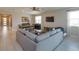 Open-concept living and dining area with neutral colors, tile floors, and lots of natural light at 1132 Sugarwood St, Davenport, FL 33837