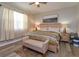 Cozy bedroom with wood-look floors, ceiling fan, nightstands, and comfortable furnishings at 1132 Sugarwood St, Davenport, FL 33837
