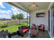 Relaxing screened patio with comfortable seating, ceiling fan and mounted television at 1132 Sugarwood St, Davenport, FL 33837