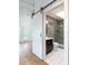 Modern bathroom featuring a sliding barn door, gray wood tile, and a glass shower at 1308 S Pennsylvania Ave # 3, Winter Park, FL 32789