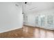 A bedroom featuring hard wood floors, track lighting, and french doors with plantation shutters at 1308 S Pennsylvania Ave # 3, Winter Park, FL 32789