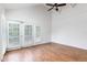 Bedroom with wood flooring, high ceilings, ceiling fan, and plantation shuttered french doors at 1308 S Pennsylvania Ave # 3, Winter Park, FL 32789