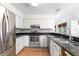 Kitchen featuring stainless steel appliances, white cabinetry, and dark granite countertops at 1308 S Pennsylvania Ave # 3, Winter Park, FL 32789