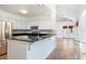 Spacious kitchen featuring an island, granite countertops, stainless steel appliances, and white cabinets at 1308 S Pennsylvania Ave # 3, Winter Park, FL 32789