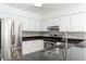 Kitchen boasting granite countertops, stainless steel appliances, and white cabinets at 1308 S Pennsylvania Ave # 3, Winter Park, FL 32789