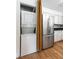 Modern laundry closet with stackable washer and dryer, and a stainless-steel refrigerator at 1308 S Pennsylvania Ave # 3, Winter Park, FL 32789