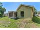 Side view of the house and backyard, featuring a screened in patio at 13146 Odyssey Lake Way, Orlando, FL 32826