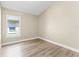 Bright bedroom with wood floors and a large window offering natural light at 13146 Odyssey Lake Way, Orlando, FL 32826