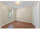 Cozy bedroom with wood floors, closet, and a bright window overlooking the neighborhood at 13146 Odyssey Lake Way, Orlando, FL 32826