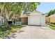 Charming home featuring a one-car garage, well-kept lawn, and inviting front porch at 13146 Odyssey Lake Way, Orlando, FL 32826