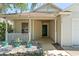 Inviting front porch with rock garden and quaint plants at 13146 Odyssey Lake Way, Orlando, FL 32826