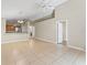 Spacious living room with tiled floors, high ceilings, and open access to the kitchen at 13146 Odyssey Lake Way, Orlando, FL 32826