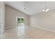 Bright living room with vaulted ceiling, tile flooring, and sliding glass doors to the lanai at 13146 Odyssey Lake Way, Orlando, FL 32826