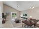 Bright living room with sliding glass doors and a vaulted ceiling at 13146 Odyssey Lake Way, Orlando, FL 32826