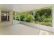 View of the screened porch with an exterior view to landscaping and lawn at 13146 Odyssey Lake Way, Orlando, FL 32826