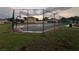 Fenced basketball court with green and red playing surface in a residential community setting at 1325 Bella Coola Dr, Orlando, FL 32828