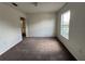 Bright bedroom offers comfortable carpet, base trim, and a sunny window with an exterior view at 1325 Bella Coola Dr, Orlando, FL 32828