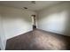 Spacious bedroom features neutral carpet and paint with a light fixture and an open doorway at 1325 Bella Coola Dr, Orlando, FL 32828