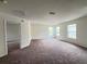 This extra-large bonus room features neutral walls, carpeting, and three windows for natural light at 1325 Bella Coola Dr, Orlando, FL 32828