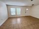 Bright living room features tile flooring and ample natural light from large windows at 1325 Bella Coola Dr, Orlando, FL 32828