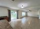 Bright living room with tile flooring, neutral paint, and sliding glass door to backyard at 1325 Bella Coola Dr, Orlando, FL 32828