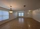Bright living room with tile floors, large windows, and a decorative chandelier at 1325 Bella Coola Dr, Orlando, FL 32828