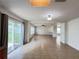 Bright living room with tile floors, a ceiling fan, and sliding glass doors to the backyard at 1325 Bella Coola Dr, Orlando, FL 32828